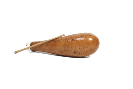 Guiro from Cuba. About  35 cm long. It is held with one hand from an opening on the other side and played with the other hand using a stick on the carved side.の写真素材