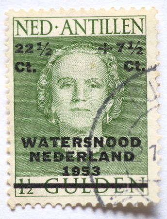 THE NETHERLANDS-1953: Dutch postage stamp from 1953 issued to raise money for the victims of the flood disaster when the dikes in the south west Netherlands broke and almost 2000 people drowned.の写真素材