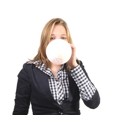 Young woman inflating a white balloon with happy birtday textの写真素材