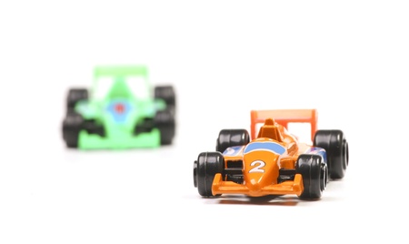 Two racing cars. Focus on the winning orange race car.の写真素材