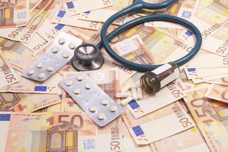 Stethoscop and medicine on a background of eurosの写真素材
