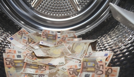Euros inside washing machine. Concept for money launderingの写真素材