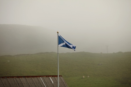 Scottish flag in foggy scottish landscapeの写真素材