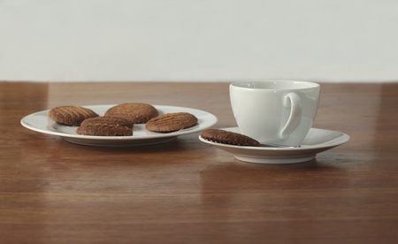 Homemade cookies with a cup of coffee on a wooden tableの写真素材
