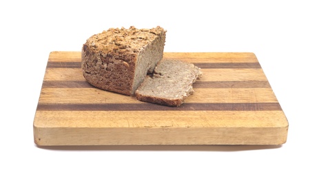 Homemade multigrain bread on a cutting boardの写真素材