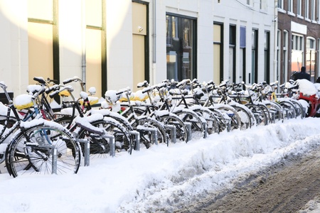 A row of snow covered bikes in the Dutch town of Groningenの写真素材