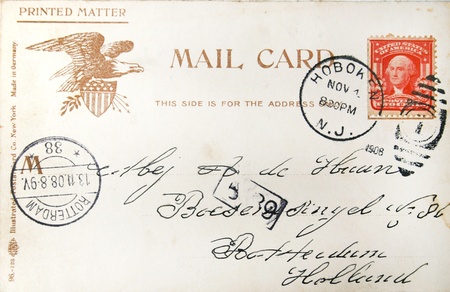 Vintage postcard with handwritten address in the Netherlands sent from the USA and postmarked in 1908 in Hoboken (USA) and Den Helder (Netherlands)のeditorial素材