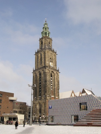 NETHERLANDS-FEB 3: Famous Martinitower and new tourist information on a snowcovered Grote Markt in Groningen on Feb 3, 2012. Part of the Grote Markt  has been demolished to make room for 'The Groninger Forum"  a new development. Tourist Information has teのeditorial素材
