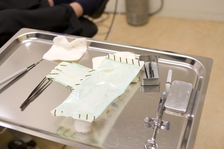 Instruments and objects on a tray after a small surgeryの写真素材
