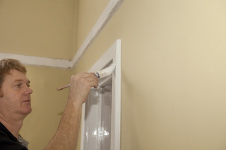 Man painting an interior windowの写真素材