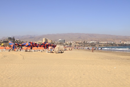 PLAYA DEL INGLES,GRAN CANARIA- MARCH 3: People on the beach and hotels in the background at Playa del ingles in Gran Canaria on march 3, 2012. Playa Ingles is the place where mass tourism in the seventies started in Europeのeditorial素材
