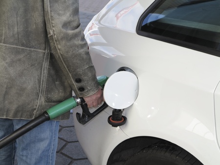 Close up of male hand topping up car tank の写真素材