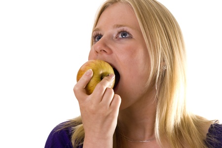 Young woman eating an appleの写真素材