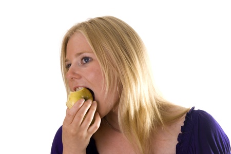 Young woman taking a bite of an appleの写真素材