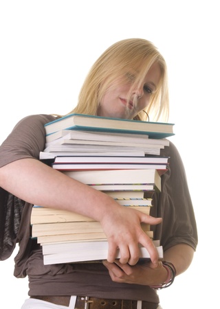 Blonde female student carries load of study booksの写真素材