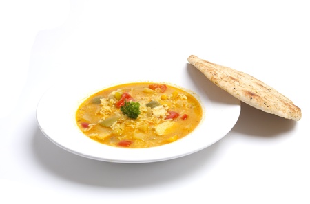 Tasty chicken curry with naan bread on the sideの写真素材