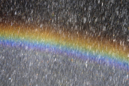 Rainbow behind waterdropsの写真素材