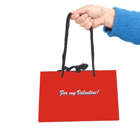 Hand in blue sweater holding red bag with text: For my valentineの写真素材