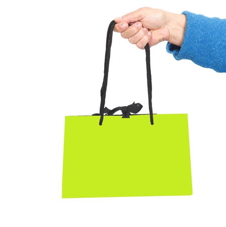 Hand in blue sweater holding green bag with black cord の写真素材