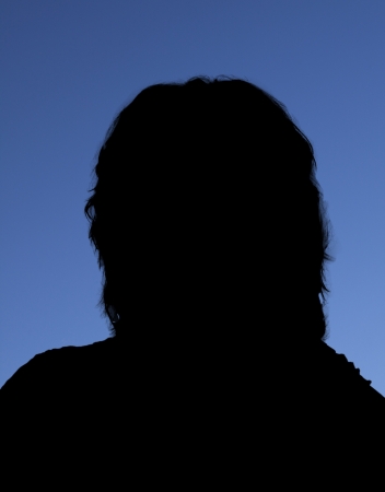 Silhouette of woman against a blue backgroundの写真素材