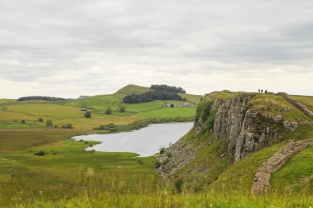 People hiking on the Hadrian wall in Northumberland, UKの写真素材
