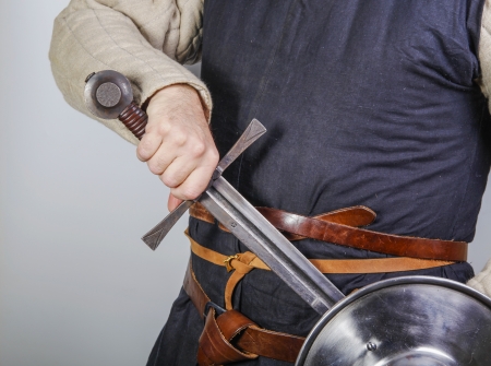 Unsheating a sword in traditional  medieval costume. の写真素材