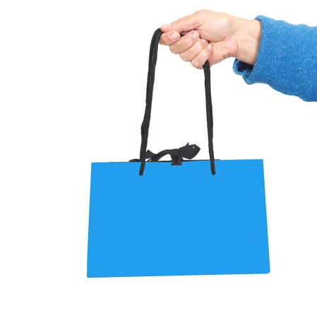 Hand in blue sweater holding blue bag with black cord の写真素材
