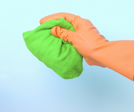 Green cleaning rag in gloved handの写真素材