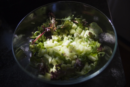 Green salad with cucumber in a glass bowlの写真素材