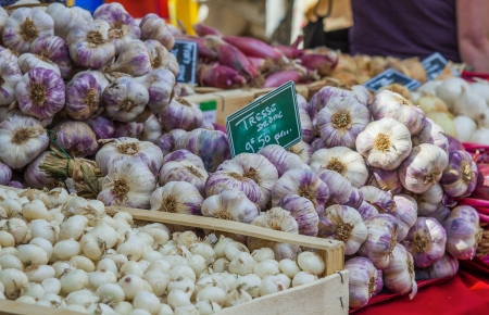 Garlic and onions on a market stall in Franceの写真素材