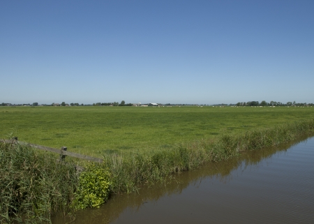 View on farmland with a canal in Groningen, the Netherlandsの写真素材