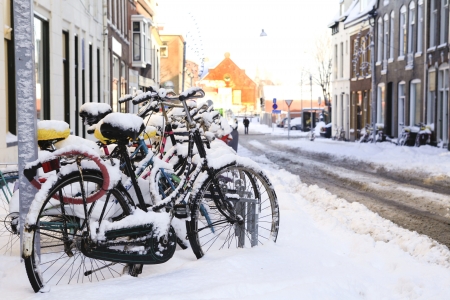 Row of bikes in the snow in Dutch Groningenの写真素材