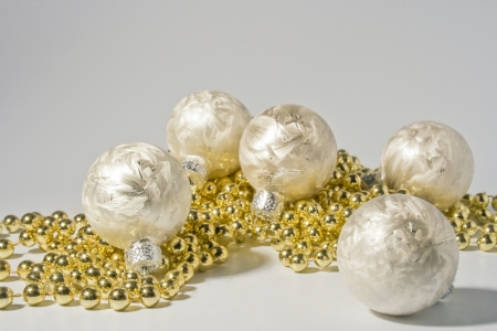 white christmas baubles with golden chainの写真素材