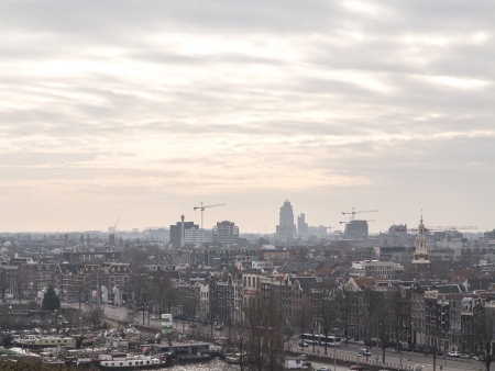 AMSTERDAM, NETHERLANDS - JAN 18,2014: Historic buildings in the center of Amsterdam and new and modern buildings at the horizon. The country's largest city is visited by over 3,5 million foreign tourists a year.

のeditorial素材