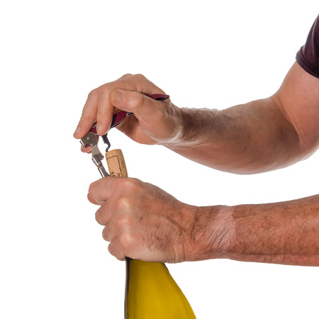 Opening a bottle of wine with a cork screw の写真素材