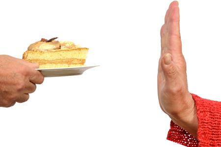 Hand stops a piece of cakeの写真素材