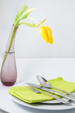Place setting in green with yellow tulipの写真素材