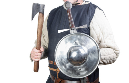 Man in medieval soldier clothing with shield and sword and axeの写真素材