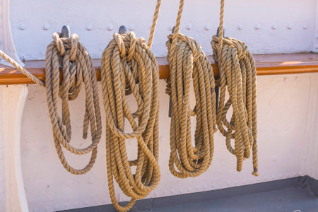 Ropes hanging on board of a big a sailing boat