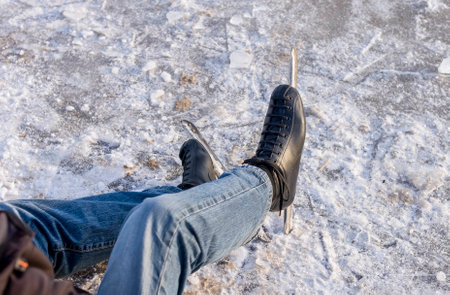 Dutch ice skater sitting on iceの写真素材
