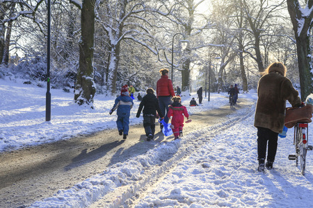 Mother with walking through childeren in the snowのeditorial素材