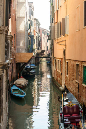 One of the many narrow canals in Venice, Italyの写真素材