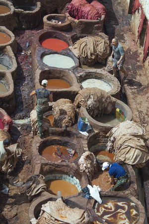 FEZ, MOROCCO - May 7: Local people painting leather at the tannery the ancient way with natural products like saffran, poppy,ceder and indigo at May 7,2013 in Fez, Morocco. のeditorial素材