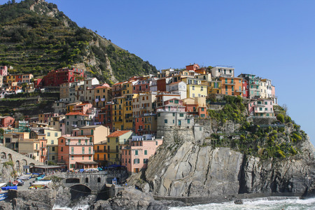beautiful town of Corniglia in cinqueterre in Italy with many colorful houses perched on a cliffの写真素材