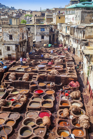 FEZ, MOROCCO - May 7:  Local people painting leather at the tannery the ancient way at May 7,2013 in Fez, Morocco.のeditorial素材