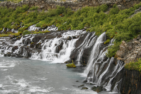 Hraunfossar, Borgarfjordur, Iceland. Underground river ends through lava as a waterfall into a wild river.

の写真素材