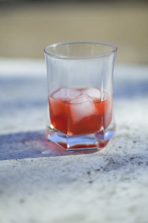 A glass of campari on a tableの写真素材