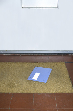 Blue envelope from the Dutch tax office on the doormatの写真素材