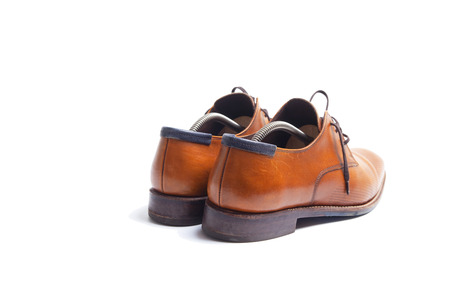 Back side of brown leather men's shoes with shoestrechers の写真素材