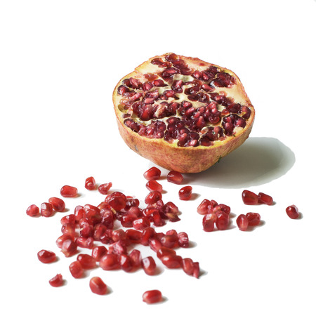 Ripe pomegranate fruit with seeds on a white の写真素材